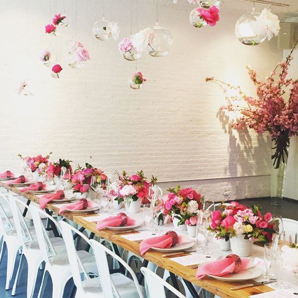 Rectangular table set with pink napkins and pink bouquets