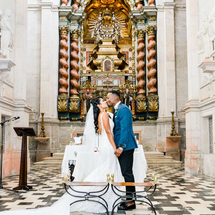 Bride and groom kissing in a church venue
