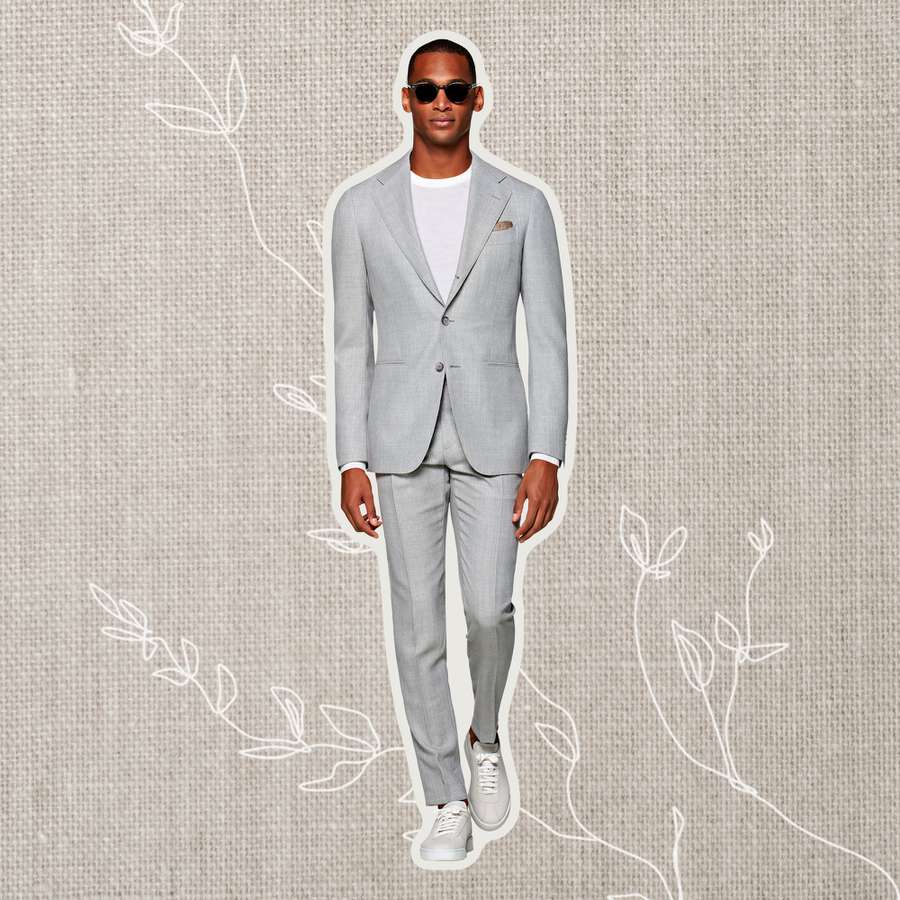 Person wearing a grey wedding suit on a flowery background