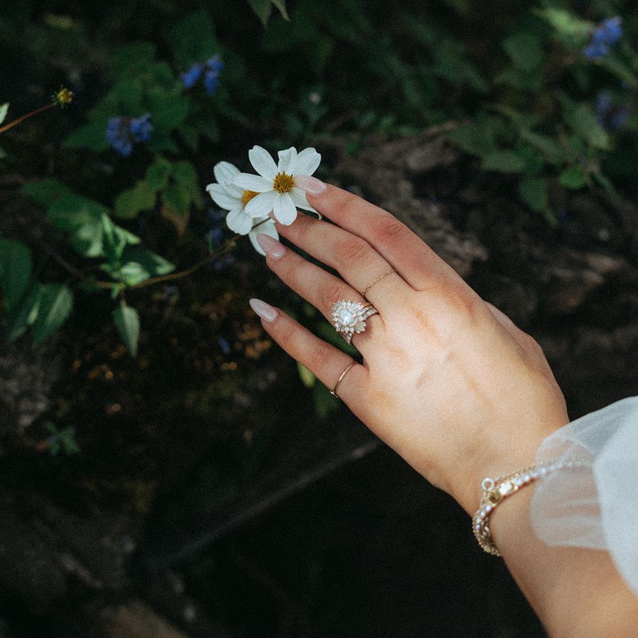 a brides hand holding a flower