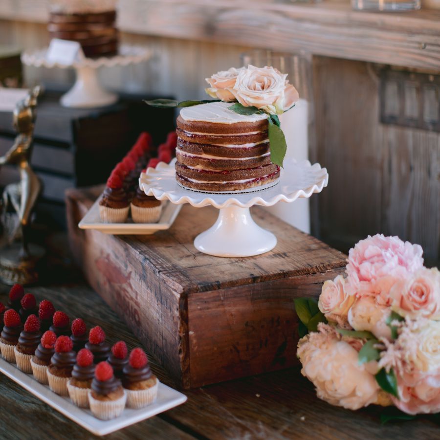 A wedding cake and dessert table.