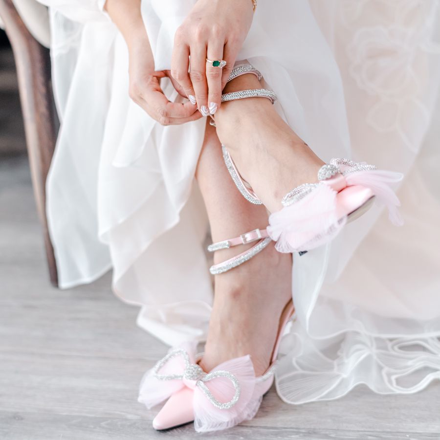 bride wearing pink shoes with a bow