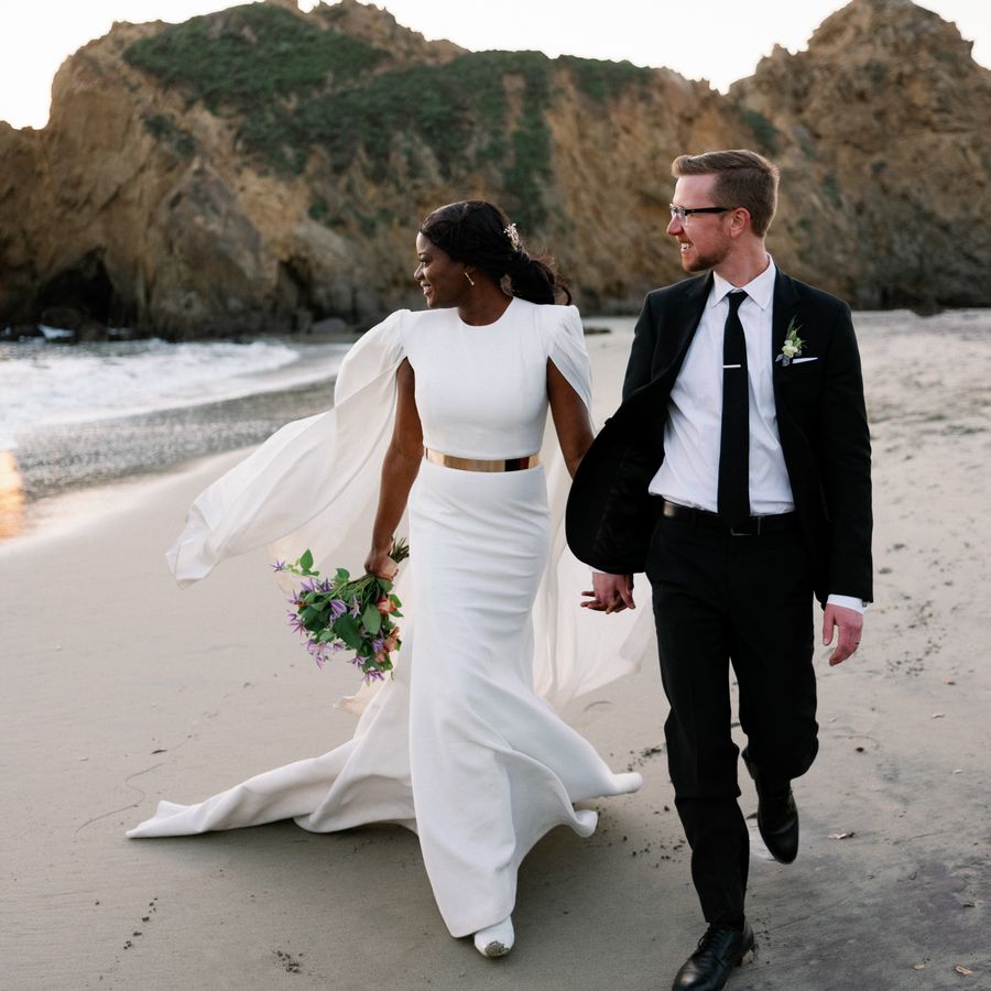 A couple walking on the beach in Big Sur, California, after their destination elopement.