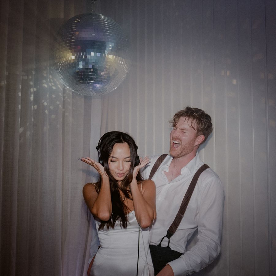 bride and groom under a disco ball