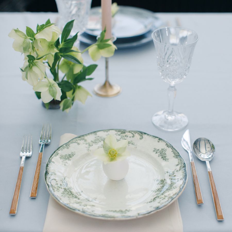 Green-and-White Floral Patterned Fine China on Table with Flatware