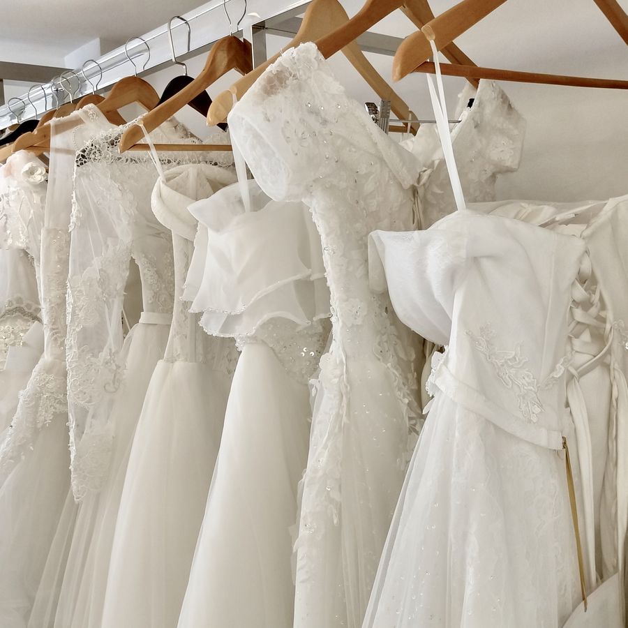 Wedding dresses on wooden hangers hanging on a rack