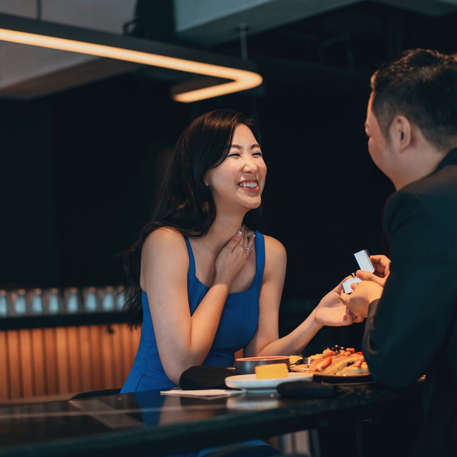 Man proposing to woman over meal