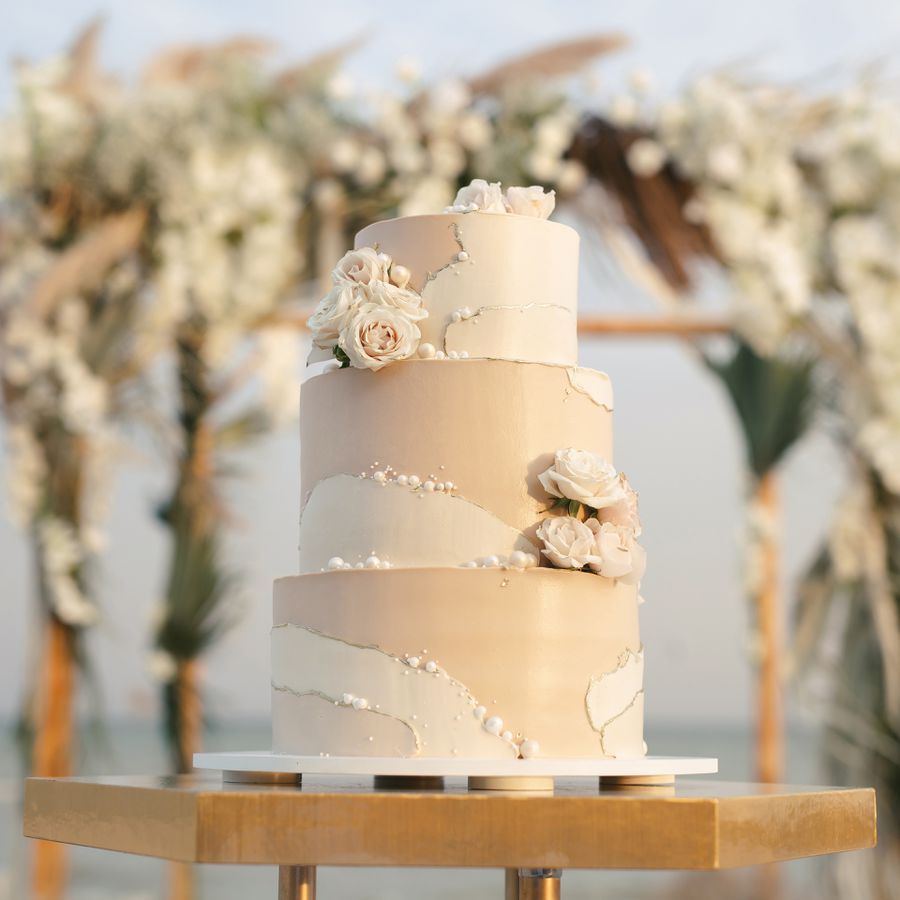 Three-tier wedding cake with pearl accents