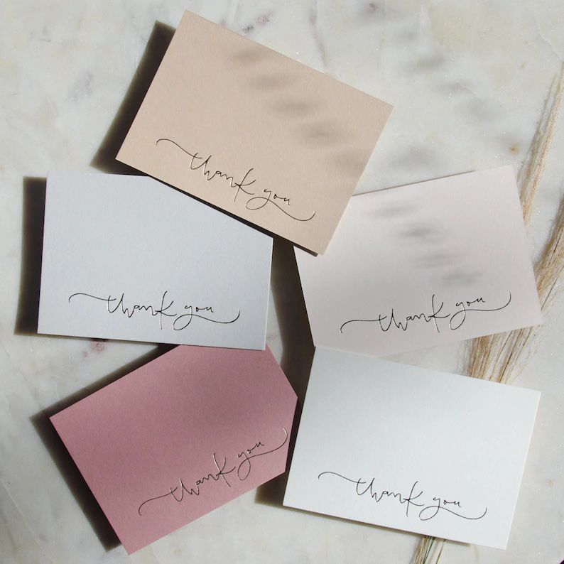 pink-toned thank-you cards with script writing