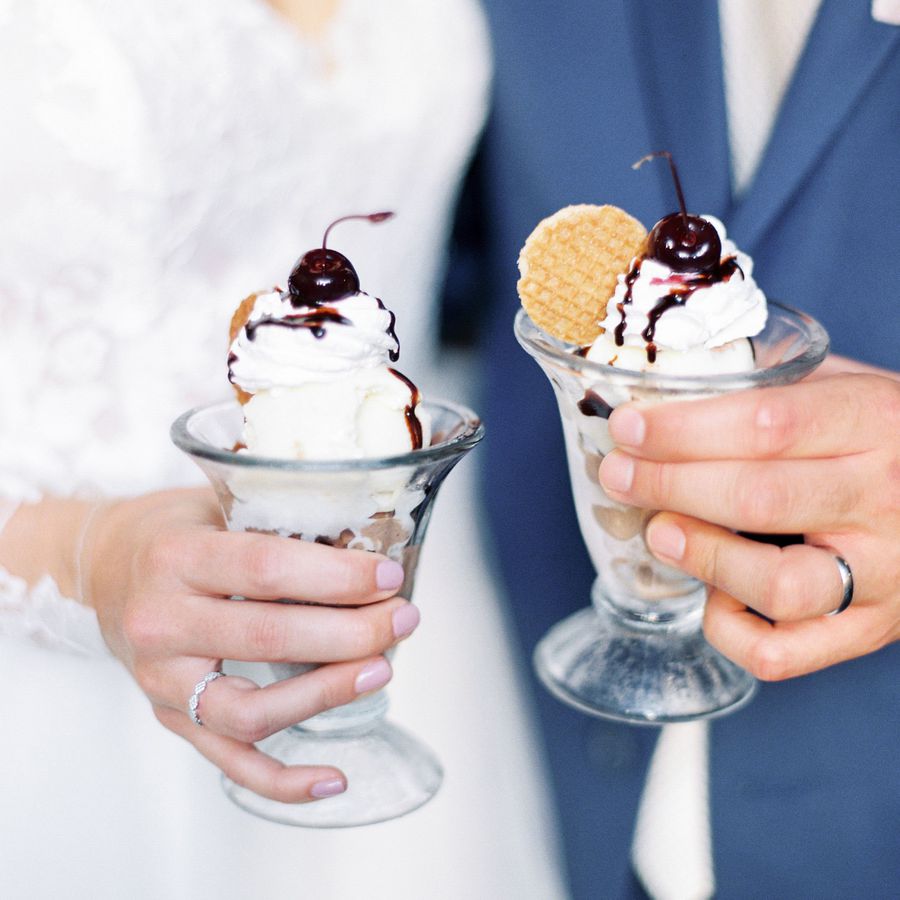 Bride and groom holding ice cream sundaes