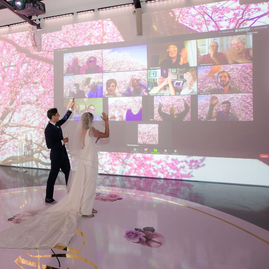 bride and groom waving to virtual guests