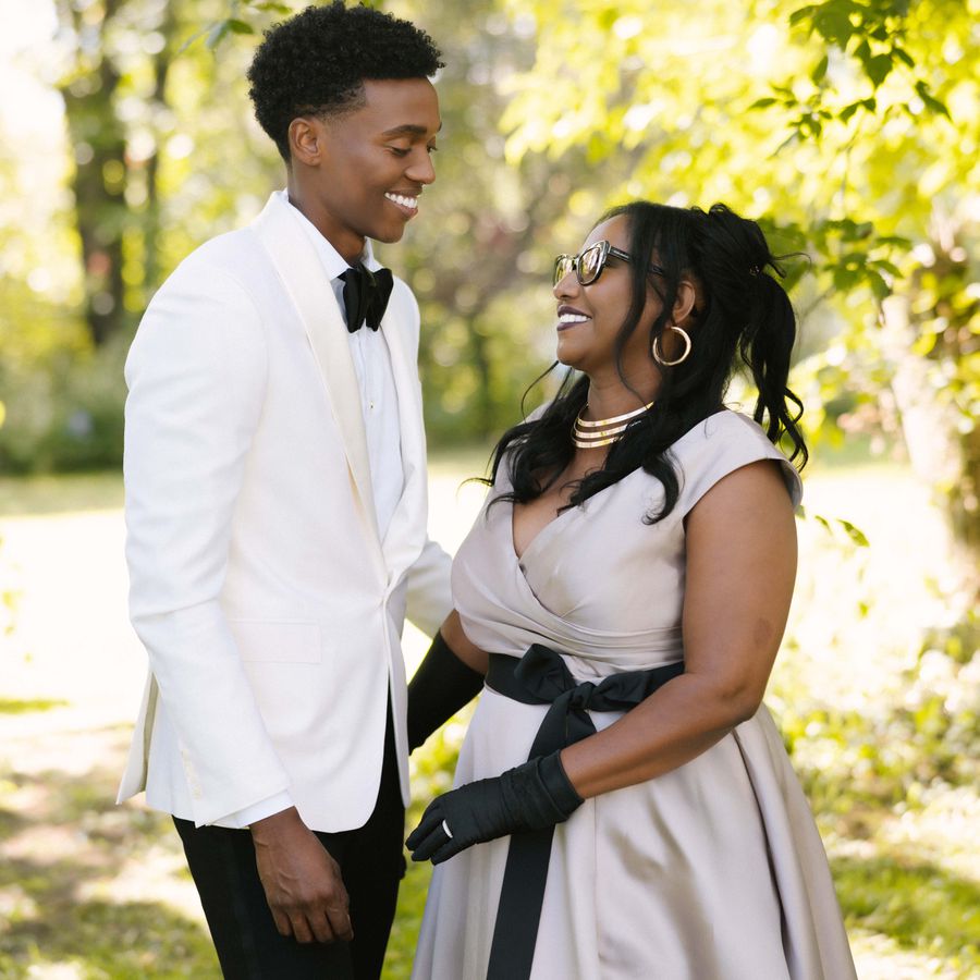 a groom and mother of the groom smiling together for a wedding portrait