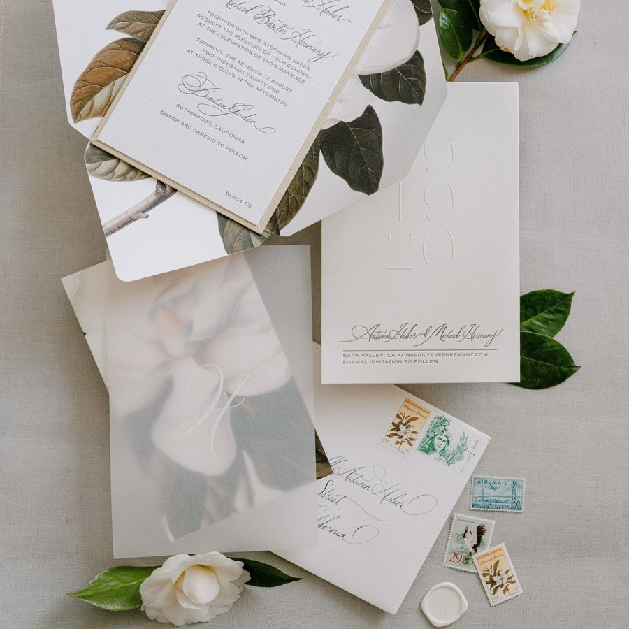 A wedding invitation suite featuring a stamp