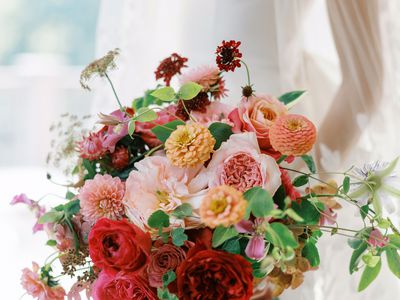 pink and burgundy wedding bouquet with garden roses, zinnias, and greenery