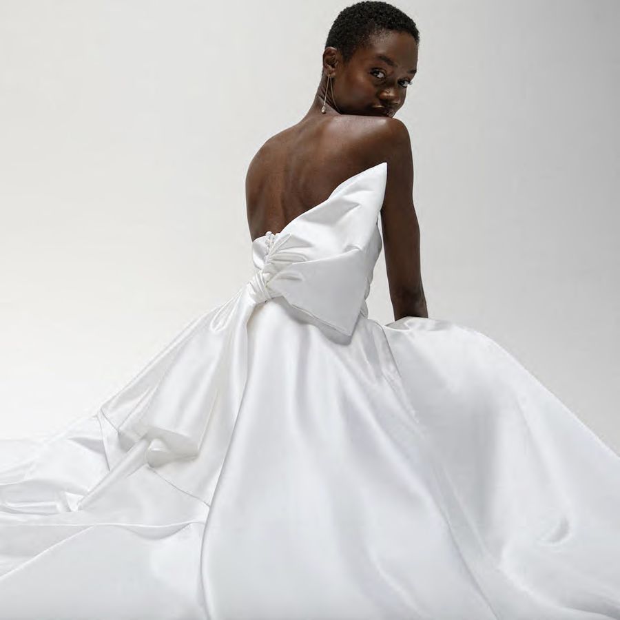 A strapless silk taffeta ball gown by Jenny Yoo with a bow on the back.