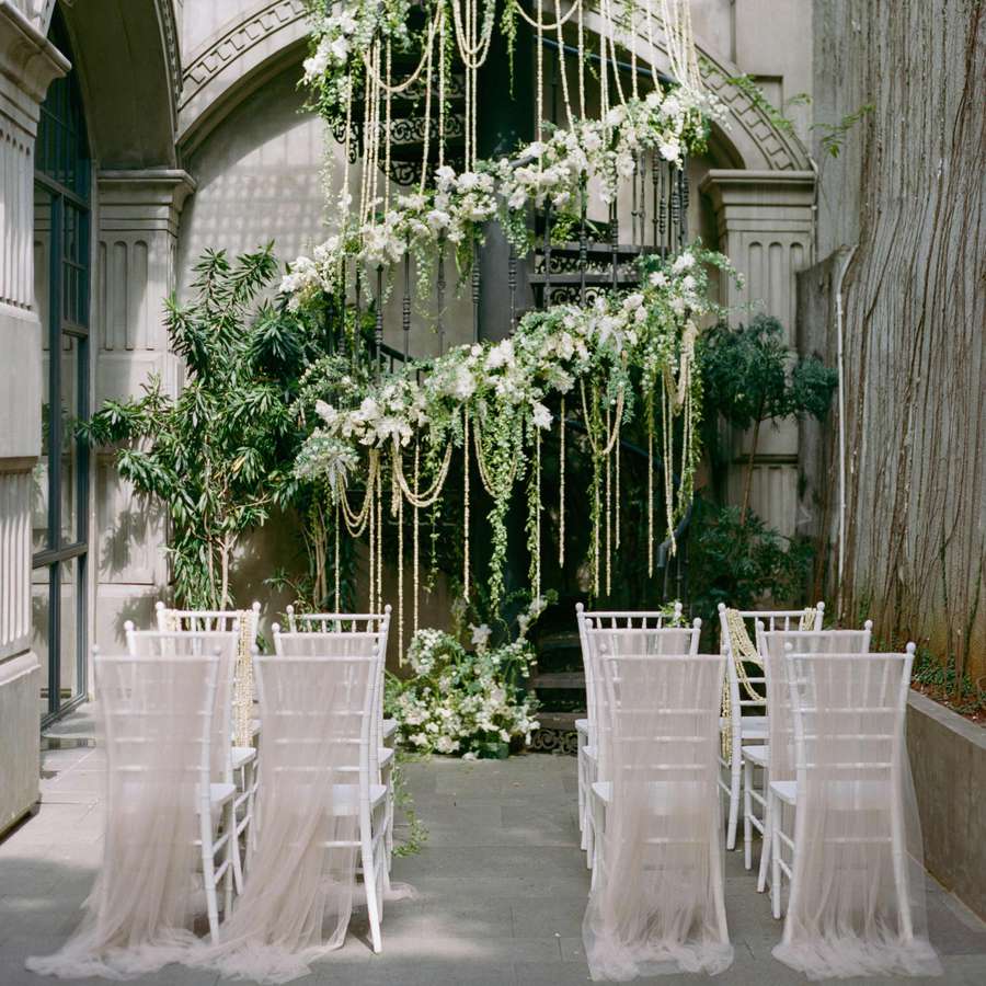 Wedding ceremony with florals on staircase