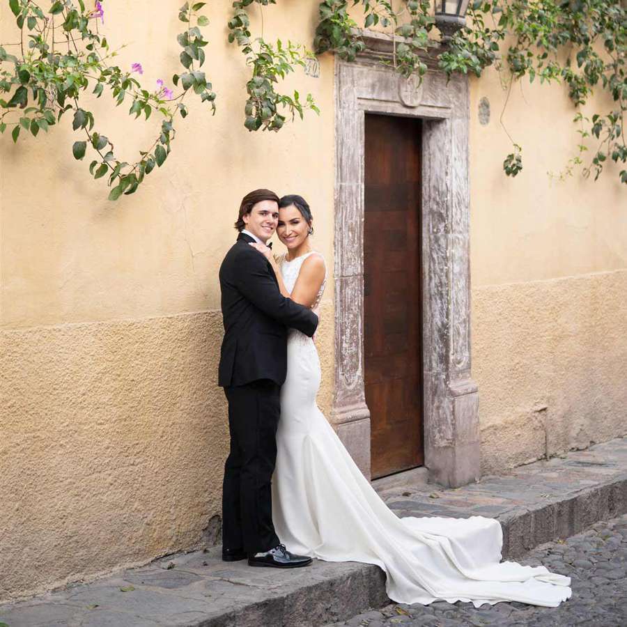 Bride and groom embrace in San Miguel, Mexico street