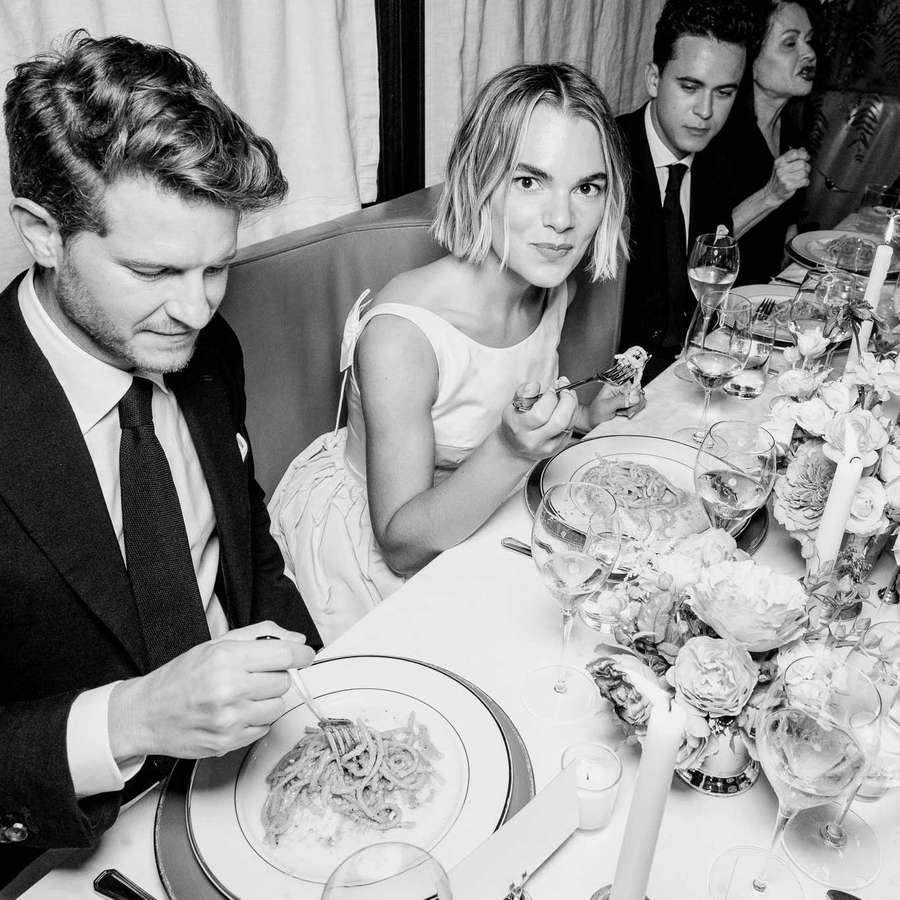 Bride and groom at seated dinner in black and white
