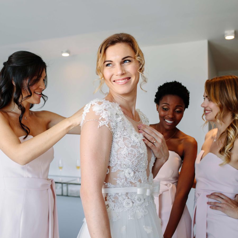 Bride with her bridesmaids getting ready