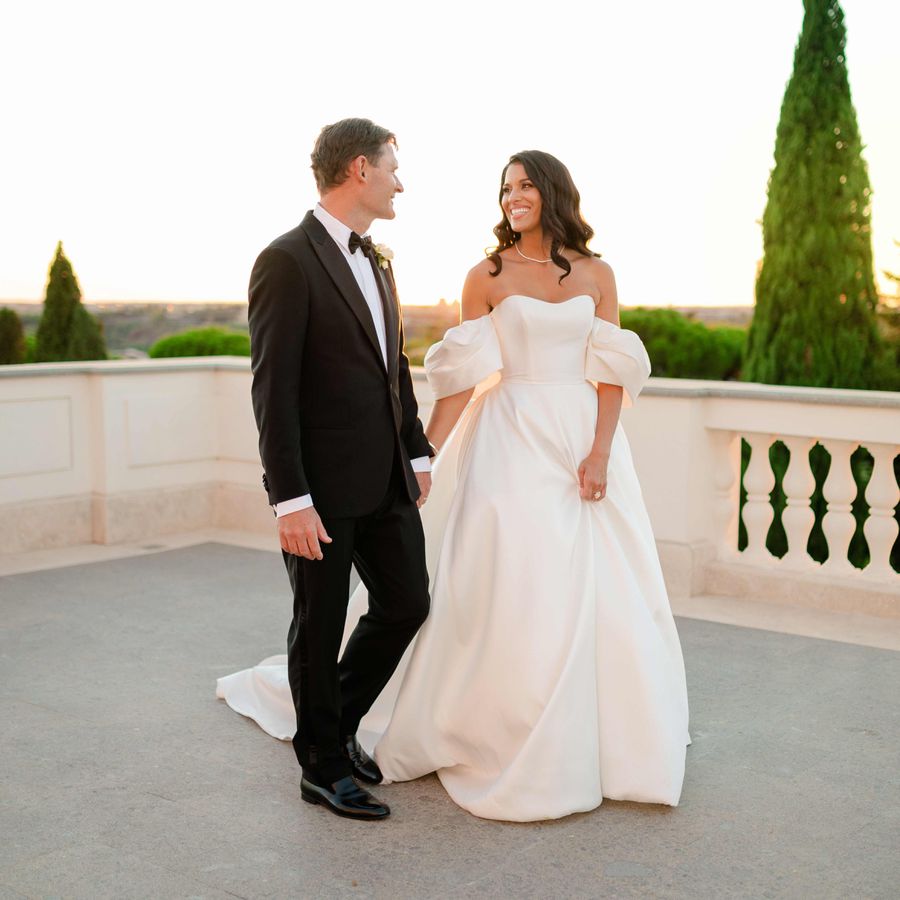 Jasmin and Thomas wedding portrait on balcony in tuxedo and off-the-shoulder gown