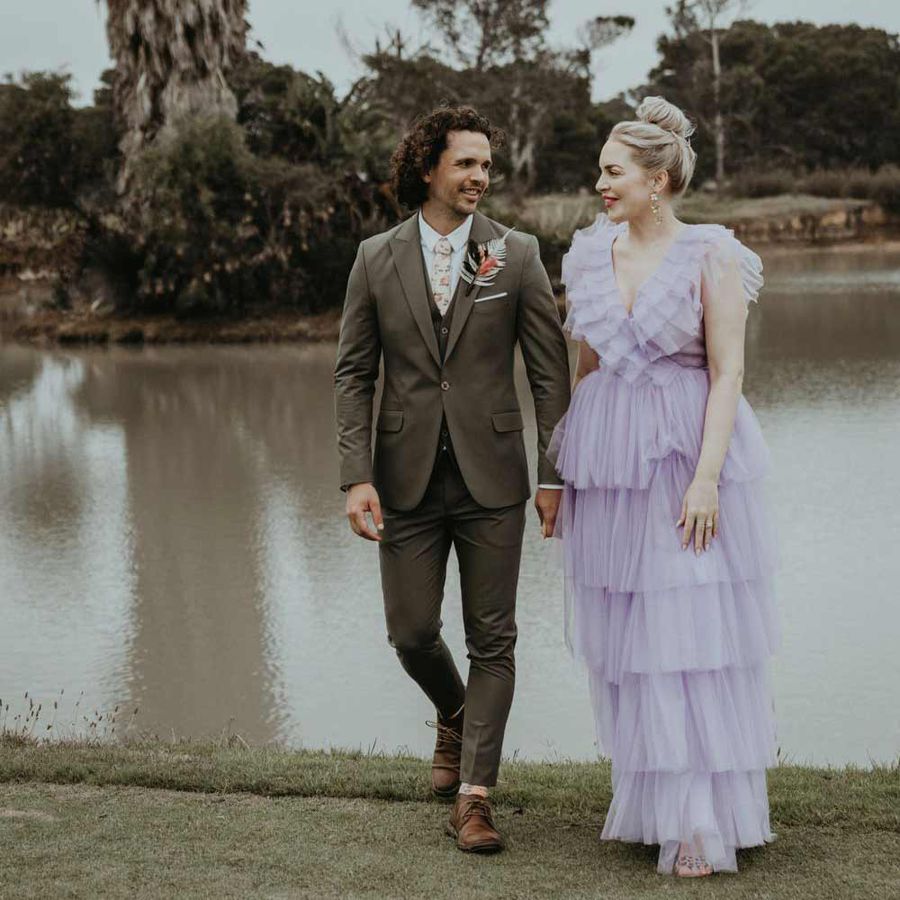 Groom in olive suit and bride in lilac dress