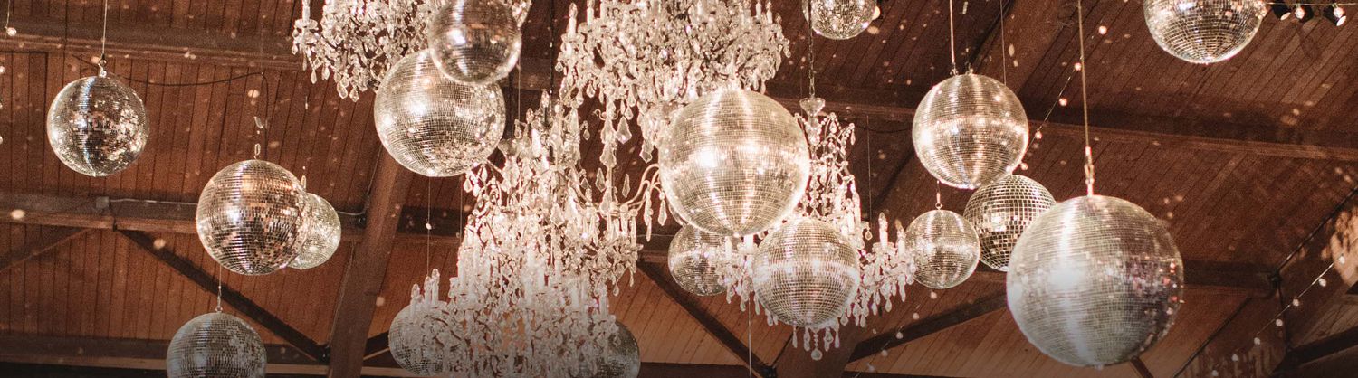 Image of chandeliers and disco balls hanging from a ceiling