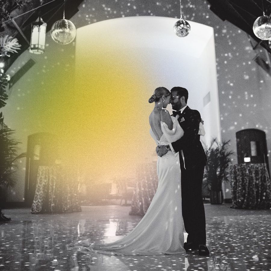 bride and groom do first dance under disco balls