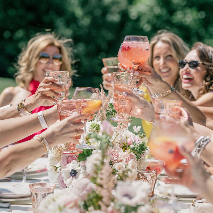 women cheers with cocktails at bridal shower