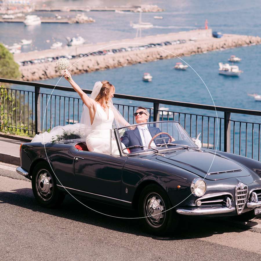 Bride and groom in car along Italian coast