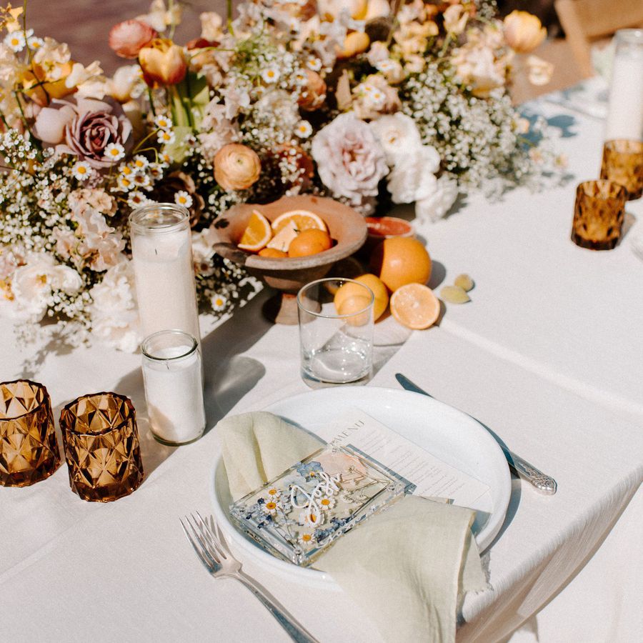A citrus-themed wedding reception table with DIY place cards.
