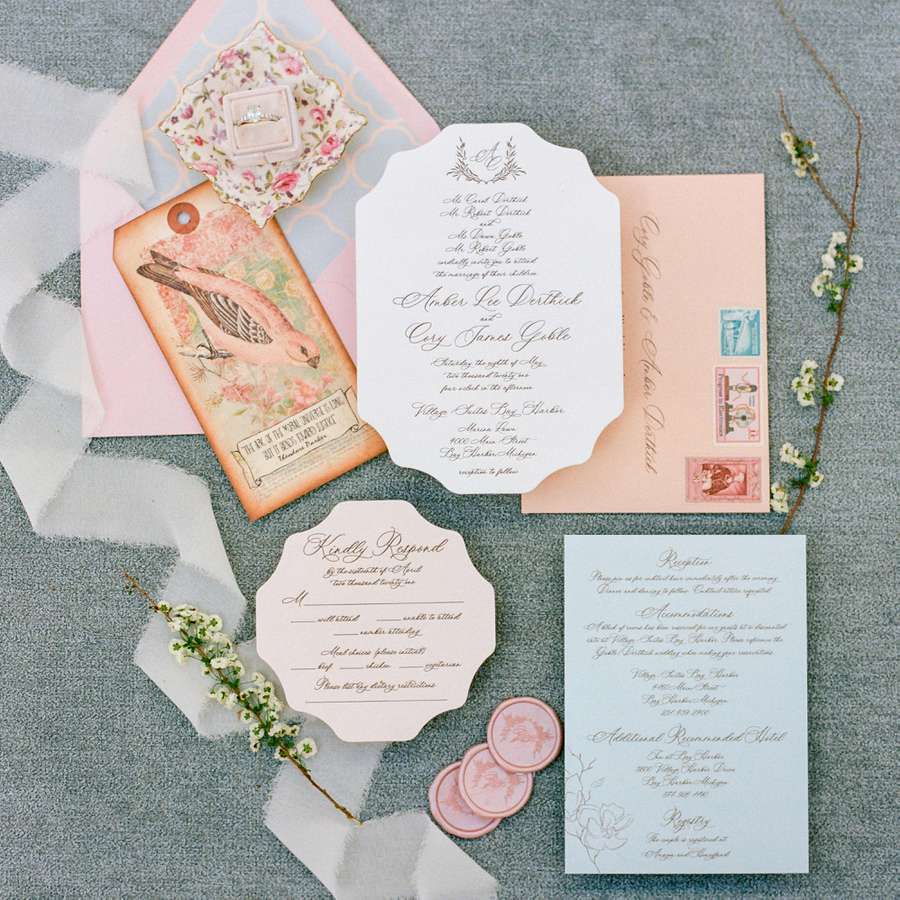 Spring wedding invitation with a pink and blue color palette, illustrated pink bird cards, and a printed envelope liner