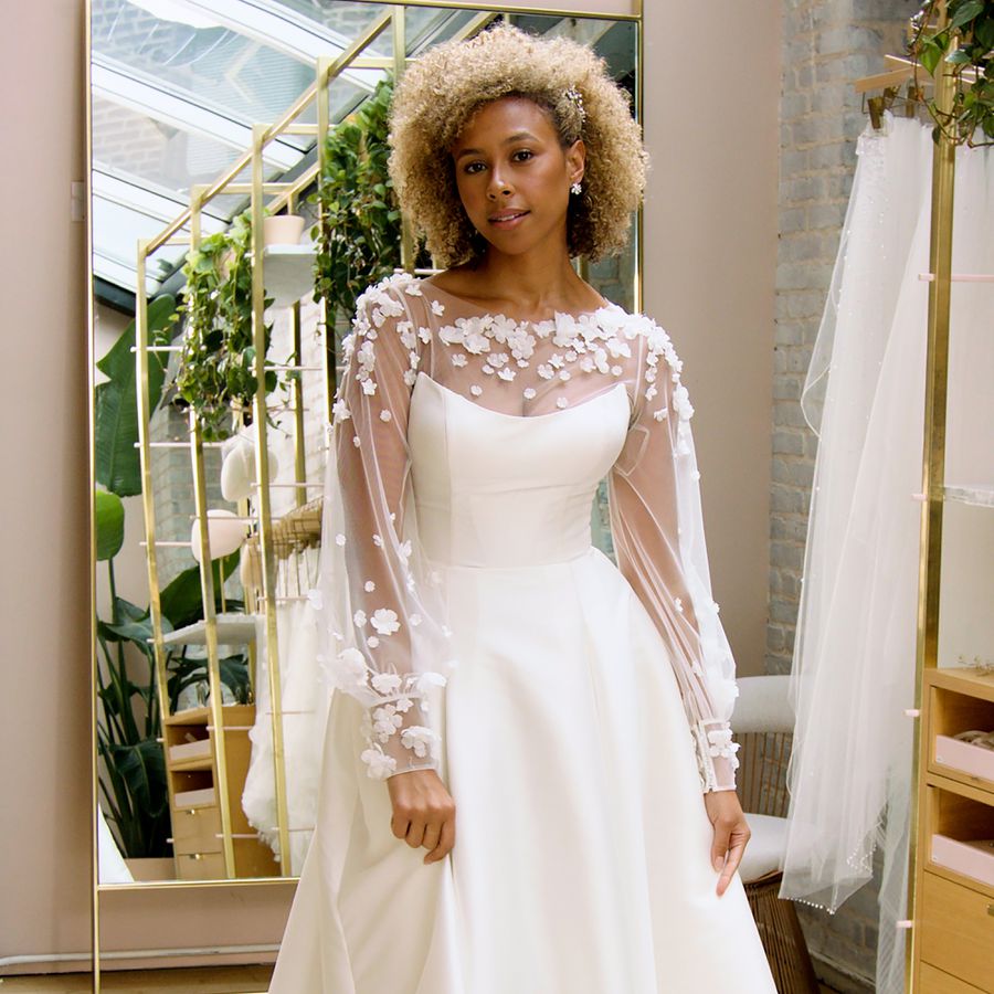 Bride in Long-Sleeve Wedding Dress with Sheer Sleeves and Floral Embroidery