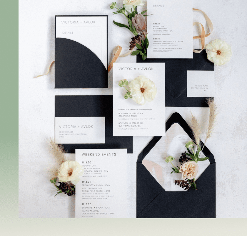 Black and white wedding invitation suite flat lay with pastel blooms